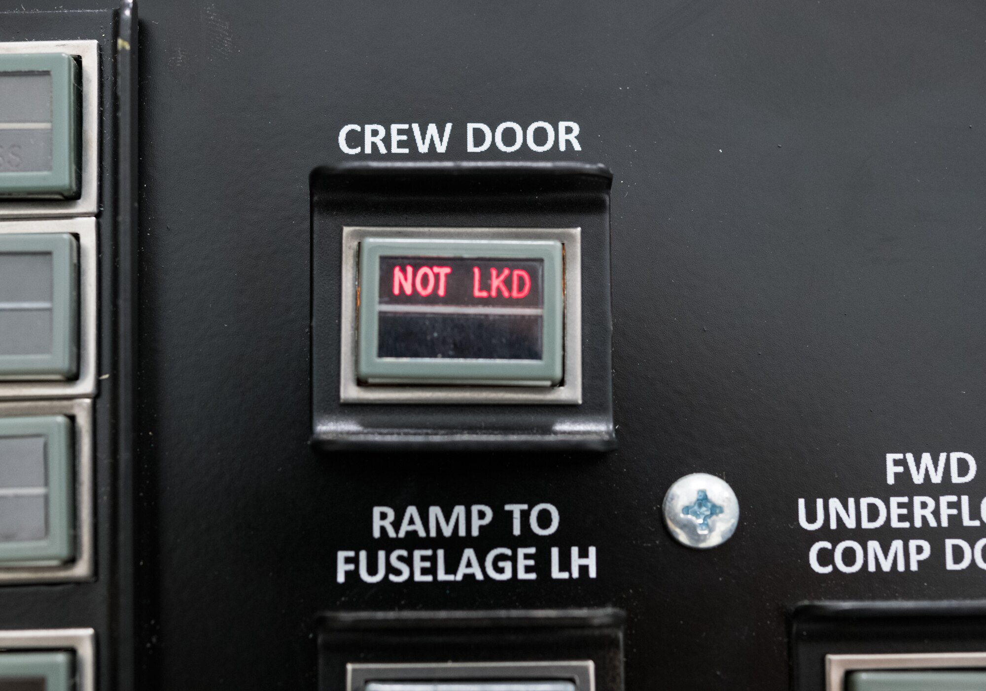 A simulated crew door “NOT LOCKED” light is illuminated on the C-5M left-hand forward loadmaster control panel trainer Jan. 28, 2020, at the 373rd Training Squadron, Detachment 3 on Dover Air Force Base, Del. During a recent mission dubbed Reach 190, an aircrew from the 9th Airlift Squadron had this light illuminate, causing a “PRESS DOOR OPEN” warning to appear on the pilot’s, copilot’s and flight engineer’s Multifunction Display Units. (U.S. Air Force photo by Roland Balik)