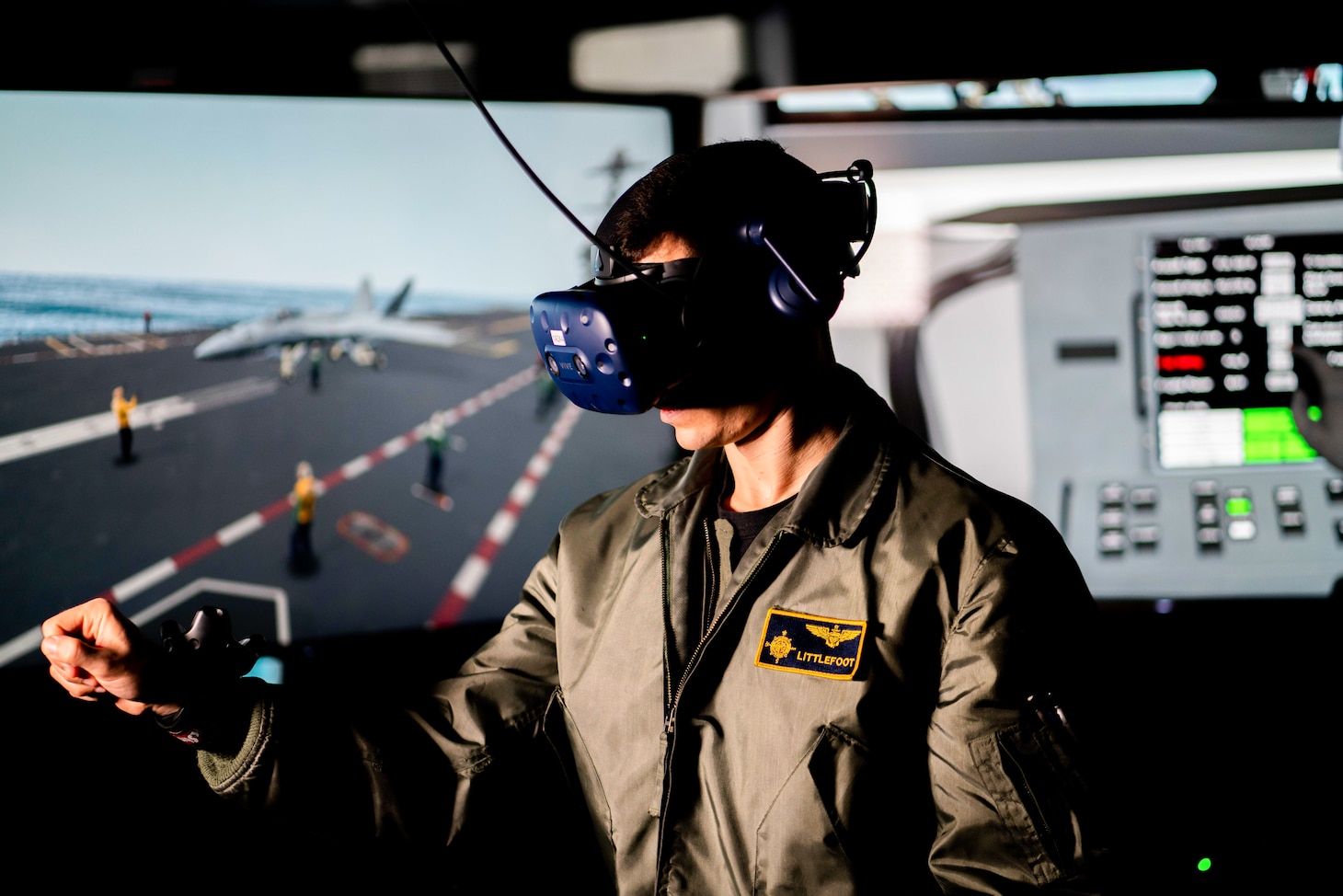 A Sailor operates a virtual reality computer though the use of a headset