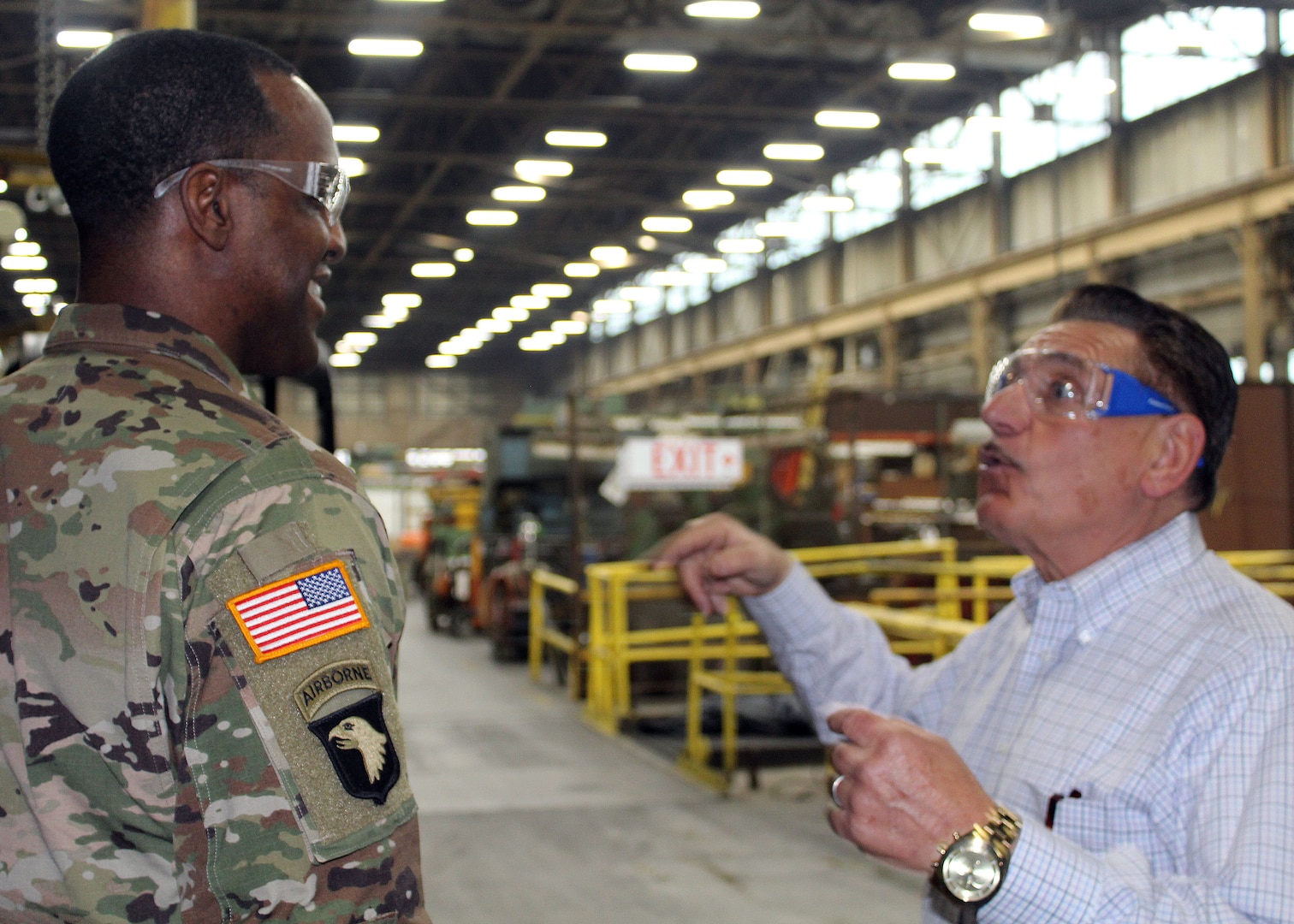DLA Troop Support Commander Army Brig. Gen. Gavin Lawrence, left, smiles as SPS Technologies Sales Manager Joseph DiGiacomo, right, provides an overview of SPS’ recapitalization of scrap material and how the industry works during a tour of the Jenkintown, Pennsylvania facility Feb. 5, 2020.