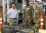 DLA Troop Support Commander Army Brig. Gen. Gavin Lawrence, center, and Industrial Hardware Director Air Force Col. Adrian Crowley, right, listen as SPS Technologies Sales Manager Joseph DiGiacomo explains the manufacturing process that goes into items at the Jenkintown, Pennsylvania facility Feb. 5, 2020.