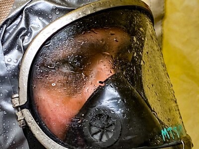 U.S. Army Pfc. Benjamin Ruehs, with the 102nd CERFP, Oregon National Guard, is sprayed off in a hasty decontamination tent at Camp Rilea near Warrenton, Oregon, January 26, 2020.