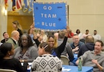 An Industrial Hardware employee holds a sign to applaud the IH supply chain during a trivia-based event Feb. 5, 2020, at DLA Troop Support in Philadelphia.