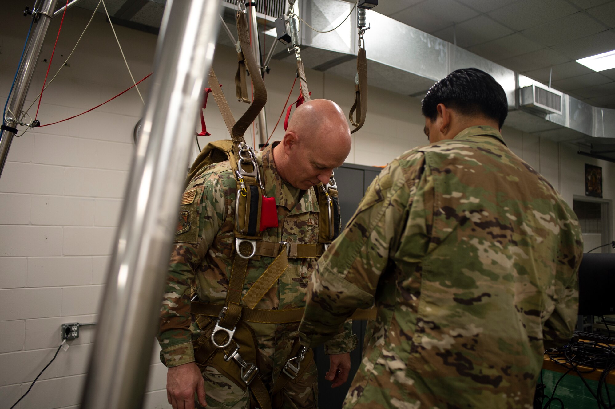 Chief Master Sgt. Daniel Simpson, the 18th Air Force command chief, gets strapped into a parachute rigger demonstration while visiting MacDill Air Force Base, Fla., Jan. 31, 2020.