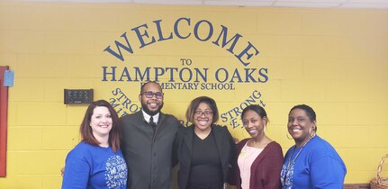 IMAGE: From left to right, Brande’ Reiter, Hampton Oaks Elementary School counselor; Guy Jackson, Naval Surface Warfare Center Dahlgren Division (NSWCDD) electrical engineer; Feline Agwumezie, NSWCDD electrical engineer; Brittany Herring, NSWCDD computer scientist; and Christie Jones; Hampton Oaks Elementary School counselor; join for a photo at the Hampton Oaks Elementary School Career Café. As members of the National Society of Black Engineers Potomac River Professionals Chapter, Agwumezie, Jackson, and Herring spoke to fourth and fifth grade students about their careers and the importance of Science, Technology, Engineering, and Mathematics in all facets of life.