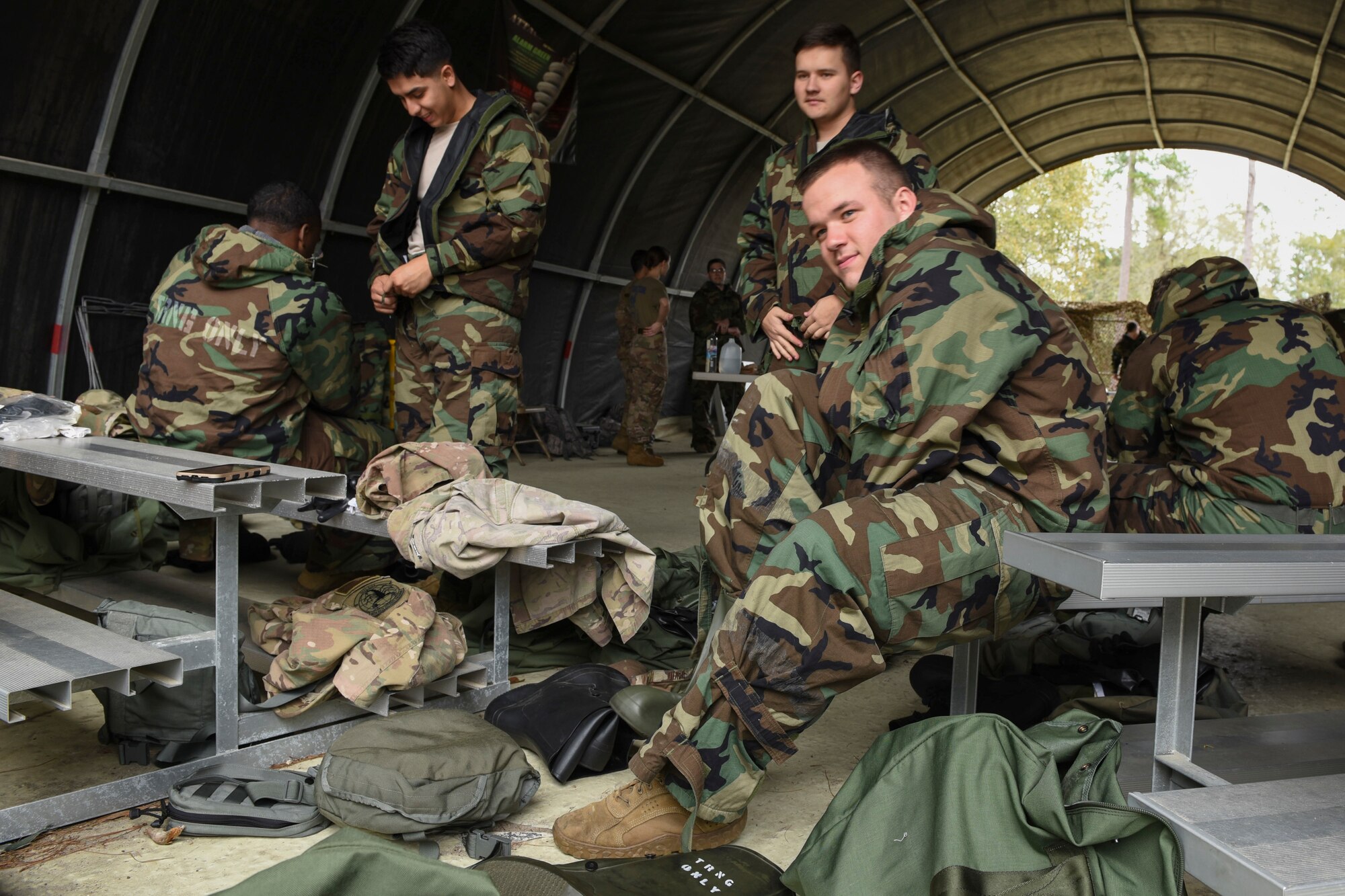 A photo of Airmen putting on mission-oriented protective posture gear during a chemical, biological, radiological, nuclear, and explosive defense training.