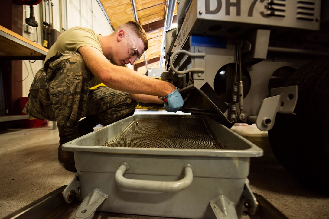 A photo of an Airman repairing a generator