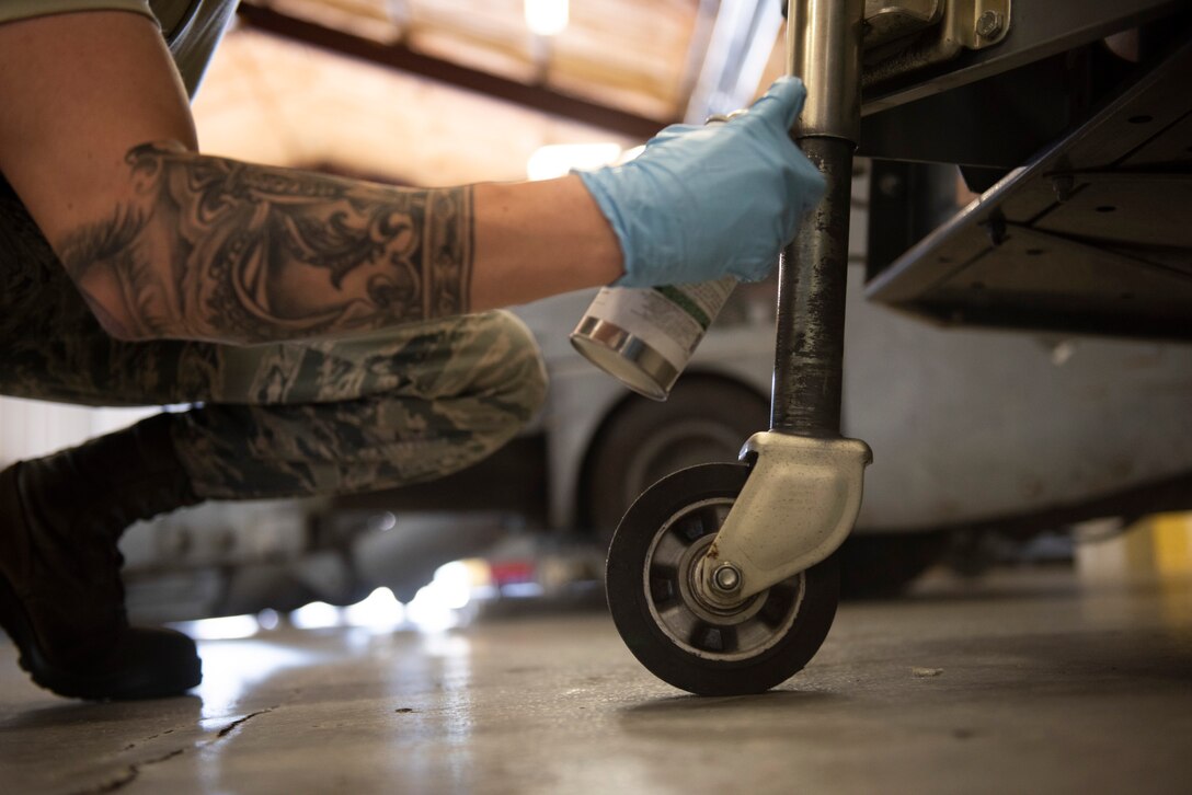 A photo on an Airman spraying a generator