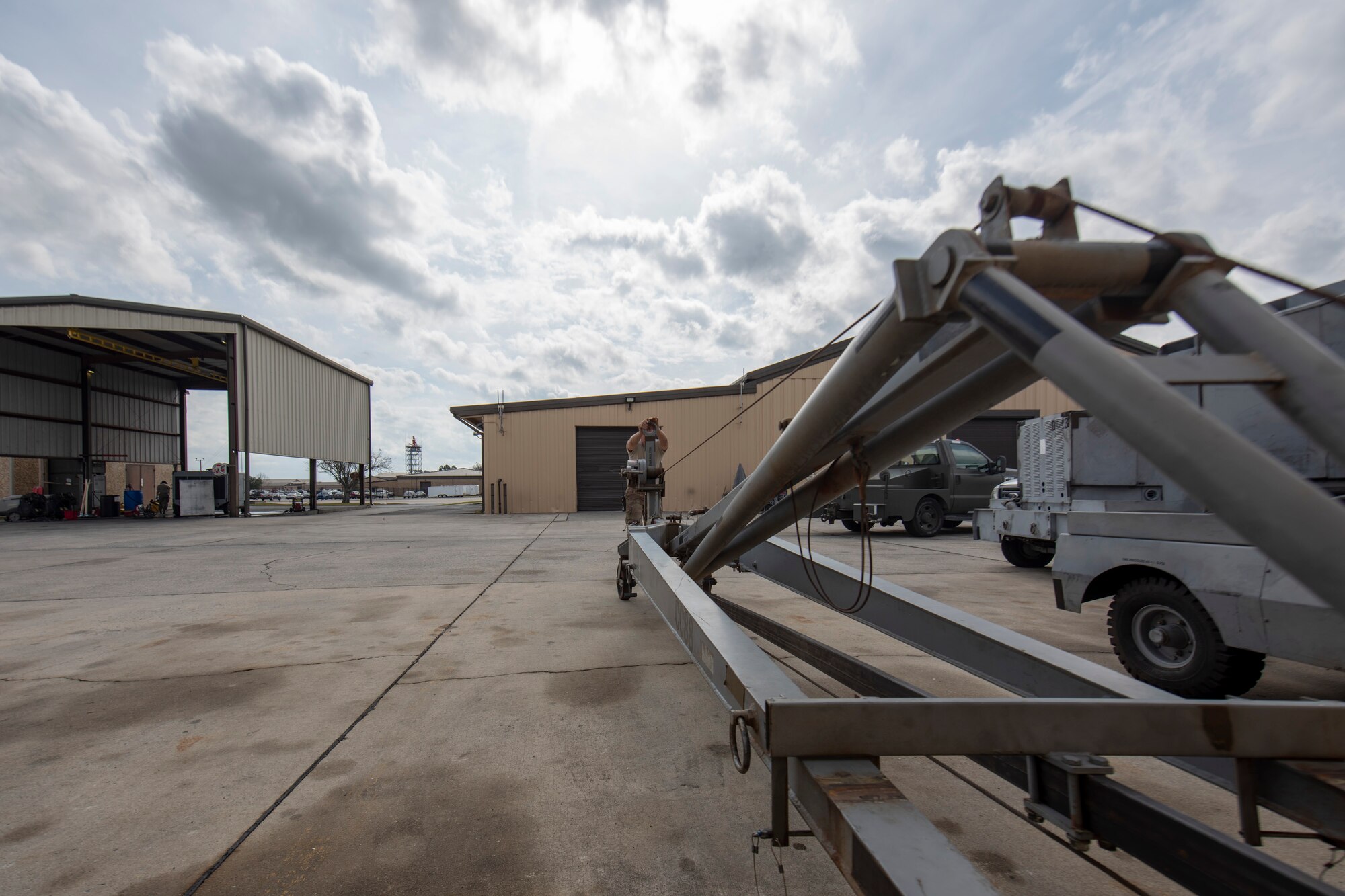 A photo of an Airman pushing a crane.
