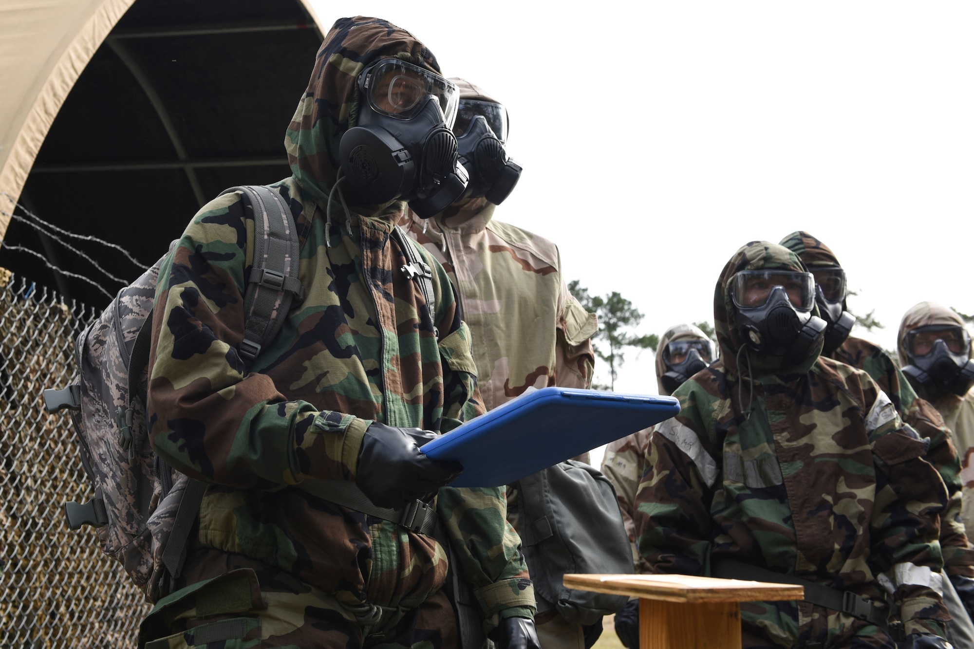 A photo of Airmen awaiting instruction during a chemical, biological, radiological, nuclear, and explosive defense training.