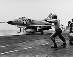 Catapult officer signals launch as A-4 Skyhawk starts down flight deck of USS Coral Sea during operations in South China Sea, March 24, 1965 (U.S. Navy/James F. Falk)