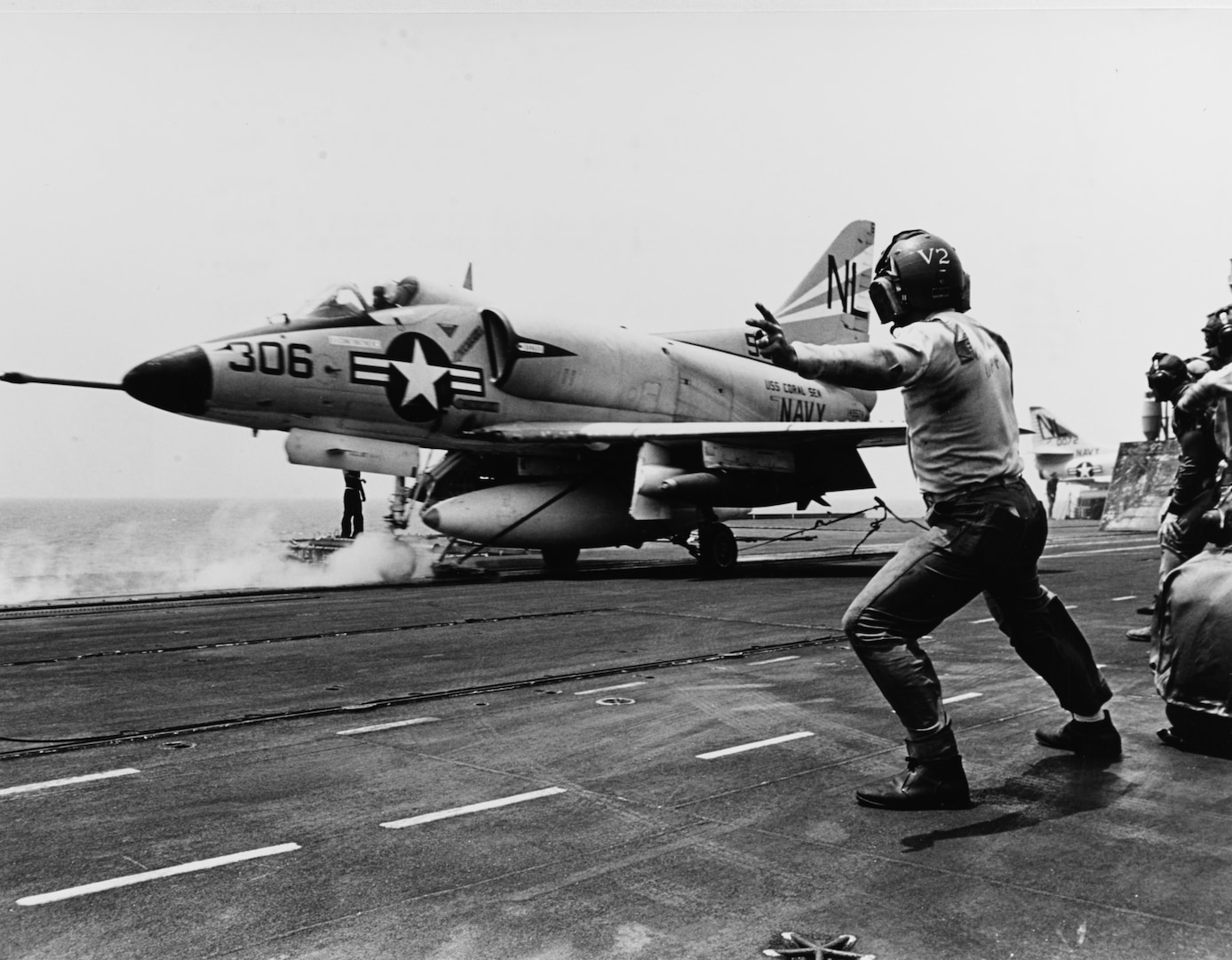 Catapult officer signals launch as A-4 Skyhawk starts down flight deck of USS Coral Sea during operations in South China Sea, March 24, 1965 (U.S. Navy/James F. Falk)