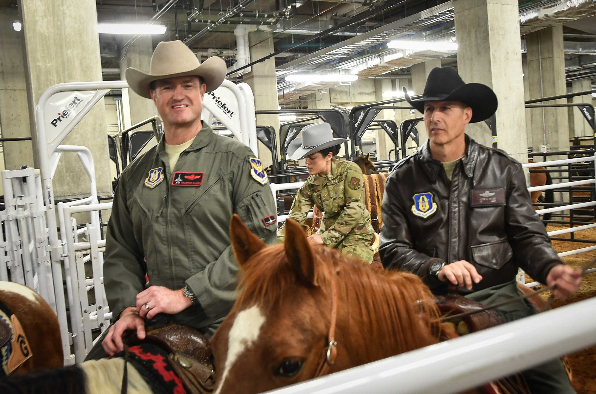 301st Fighter Wing Vice Commander Col. Randall Cason, Senior Airman Brooke Pirrone, 301 FW tactical aircraft maintenance crew chief, and 301 FW Director of Staff Col. Kevin Zeller represent the wing riding in the Grand Entry at the Fort Worth Stock Show and Rodeo at Dickie’s Arena on February 3, 2020. The 301 FW has been honored to ride in the procession of Military Appreciation Day since 2012. (U.S. Air Force Photo by Master Sgt. Jeremy Roman)
