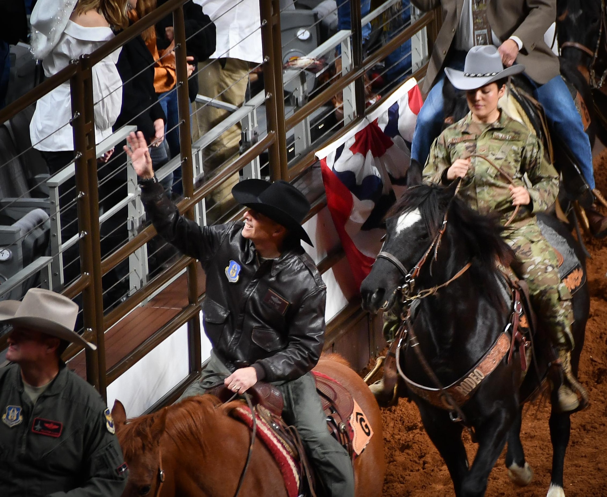 301st Fighter Wing Vice Commander Col. Randall Cason, Senior Airman Brooke Pirrone, 301 FW tactical aircraft maintenance crew chief, and 301 FW Director of Staff Col. Kevin Zeller greet the crowd during the Grand Entry at the Fort Worth Stock Show and Rodeo at Dickie’s Arena on February 3, 2020. Among the procession was Fort Worth Mayor Betsy Price and U.S. Naval Air Station Joint Reserve Base Fort Worth Commander Capt. Jonathan Townsend. (U.S. Air Force Photo by Master Sgt. Jeremy Roman)