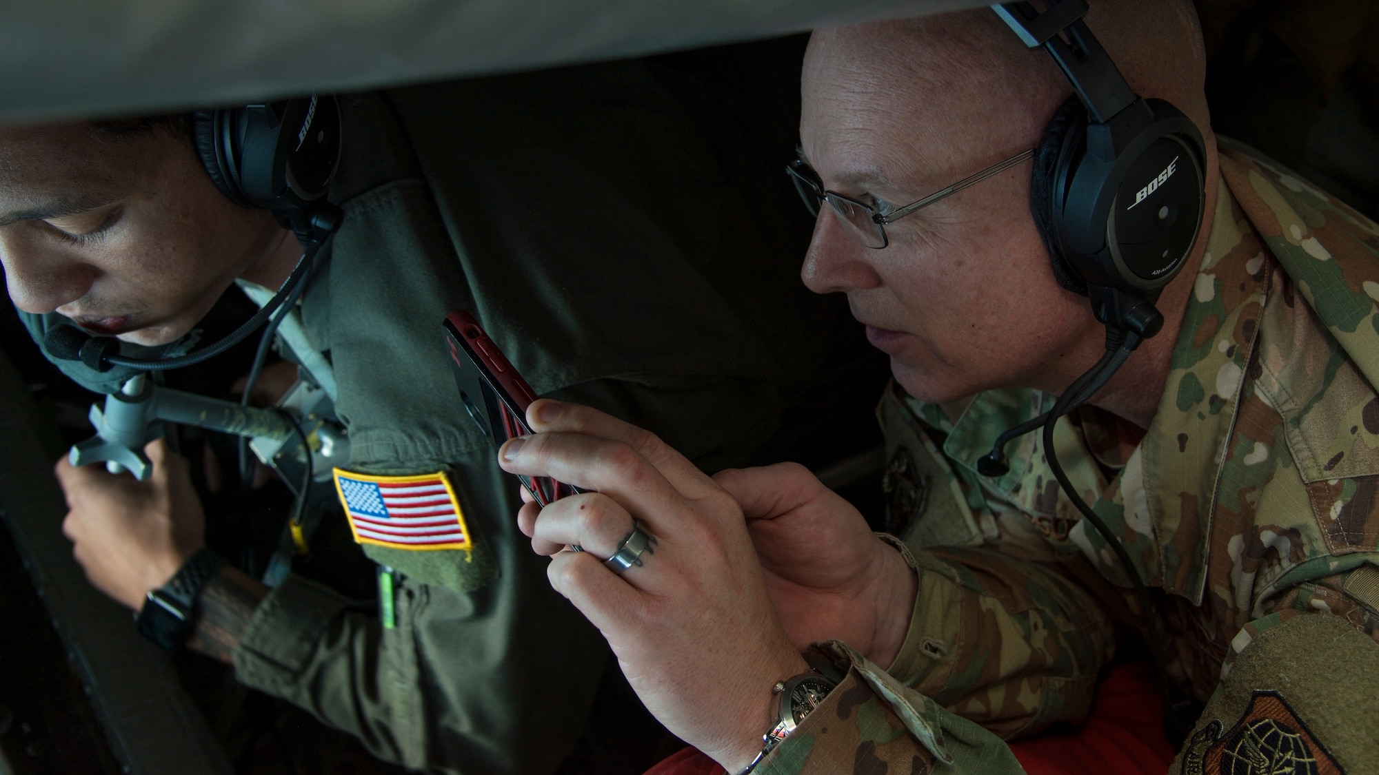 U.S. Air Force Chief Master Sgt. Daniel Simpson, the 18th Air Force command chief, views Airman 1st Class Malachi Greman, a 50th Air Refueling Squadron boom operator, refuel a KC-46 Pegasus from McConnell Air Force Base, Kan., aboard a KC-135 Stratotanker, Jan. 30, 2020.