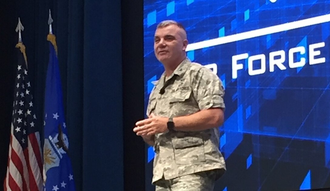 Retired Col. Robert Swanson Jr. speaks in front of hundreds of graduate students and faculty Jan. 16 at the Air Force Institute of Technology at Wright-Patterson Air Force Base. Swanson is a suicide attempt survivor and shared his insights on recovery and getting mental health help. (U.S. Air Force photo/Katie Scott)