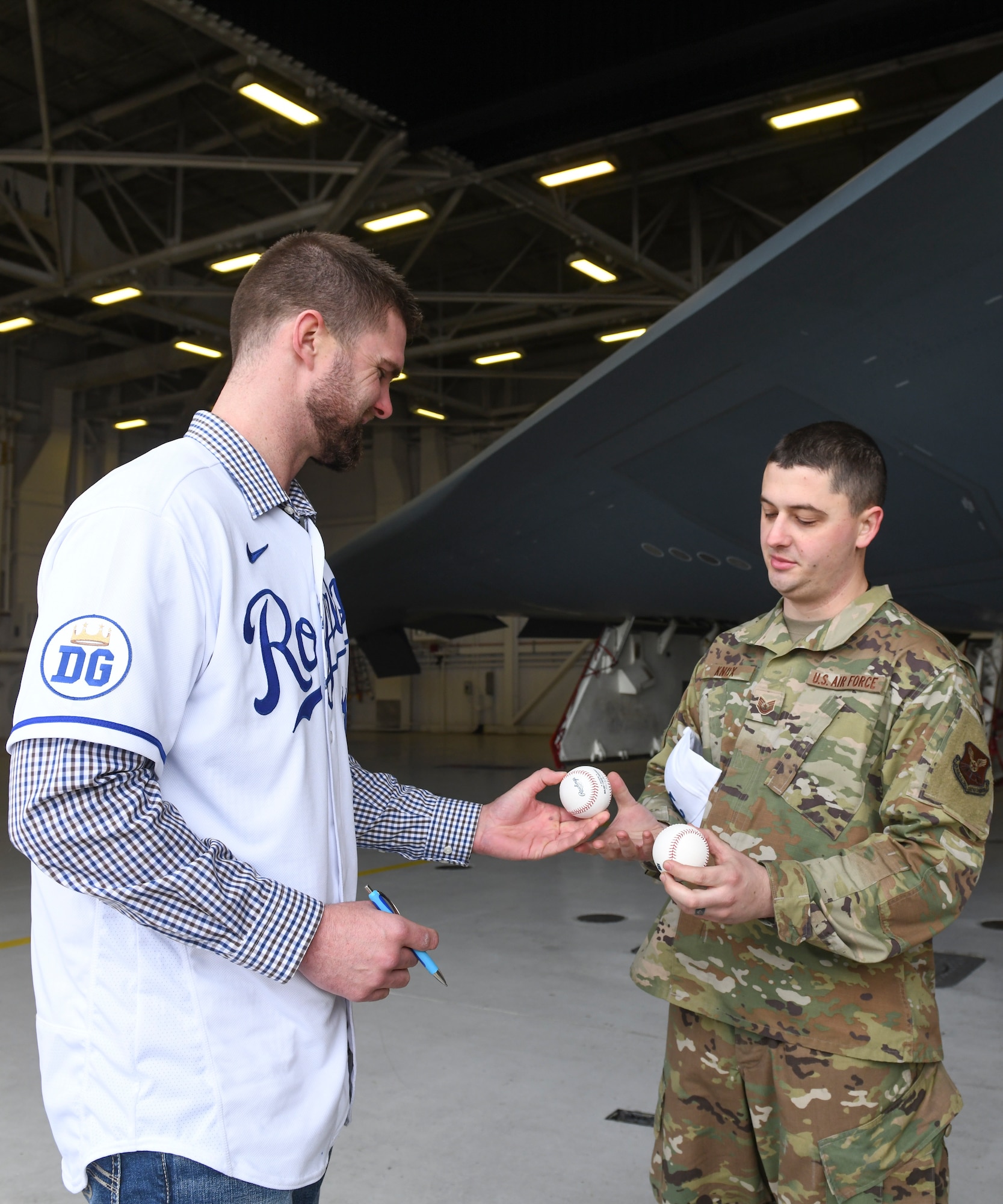 Derek “Bubba” Starling, left, a Kansas City Royals outfielder, gives U.S. Air Force Tech. Sgt. David Knox, right, a 509th Maintenance Group aerospace ground equipment inspections section chief, a signed baseball during a team visit at Whiteman Air Force Base, Mo., Jan. 30, 2020. During the visit, KC Royals team members ate lunch with Airmen, toured a B-2 Spirit Stealth Bomber and participated in a meet and greet while learning about the Airmen and the jobs they perform. (U.S. Air Force photo by Staff Sgt. Sadie Colbert)