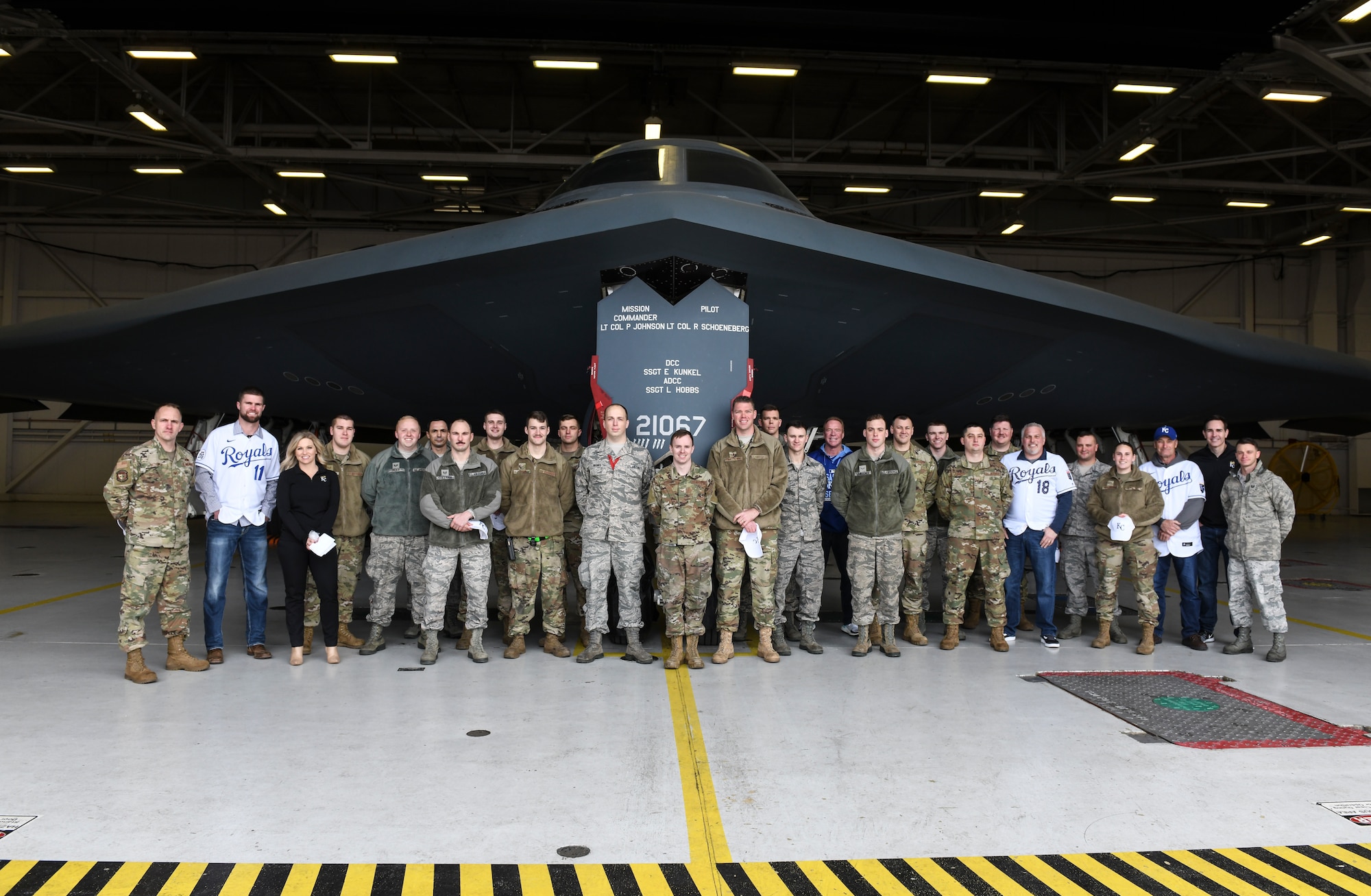 Kansas City Royals team members stand for a photo with 509th Bomb Wing Airmen at Whiteman Air Force Base, Jan. 30, 2020. During the visit, KC Royals team members ate lunch with Airmen, toured a B-2 Spirit Stealth Bomber and participated in a meet and greet while learning about the Airmen and the jobs they perform. (U.S. Air Force photo by Staff Sgt. Sadie Colbert)