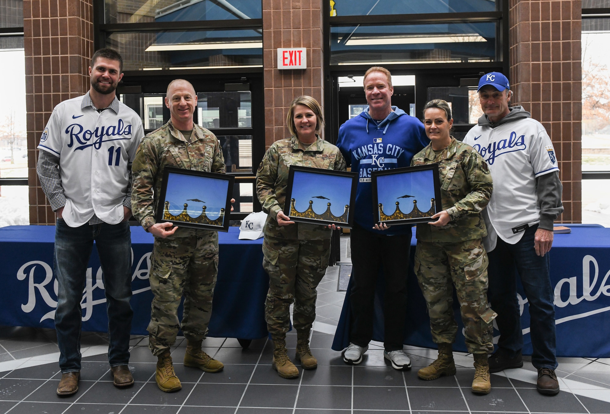 Kansas City Royals team members present a commemorative B-2 Spirit photo to 509th Bomb Wing and 131st Bomb Wing leadership during a visit at Whiteman Air Force Base, Mo., Jan. 30, 2020. During the visit, KC Royals team members ate lunch with Airmen, toured a B-2 Spirit Stealth Bomber and participated in a meet and greet while learning about the Airmen and the jobs they perform. (U.S. Air Force photo by Staff Sgt. Sadie Colbert)