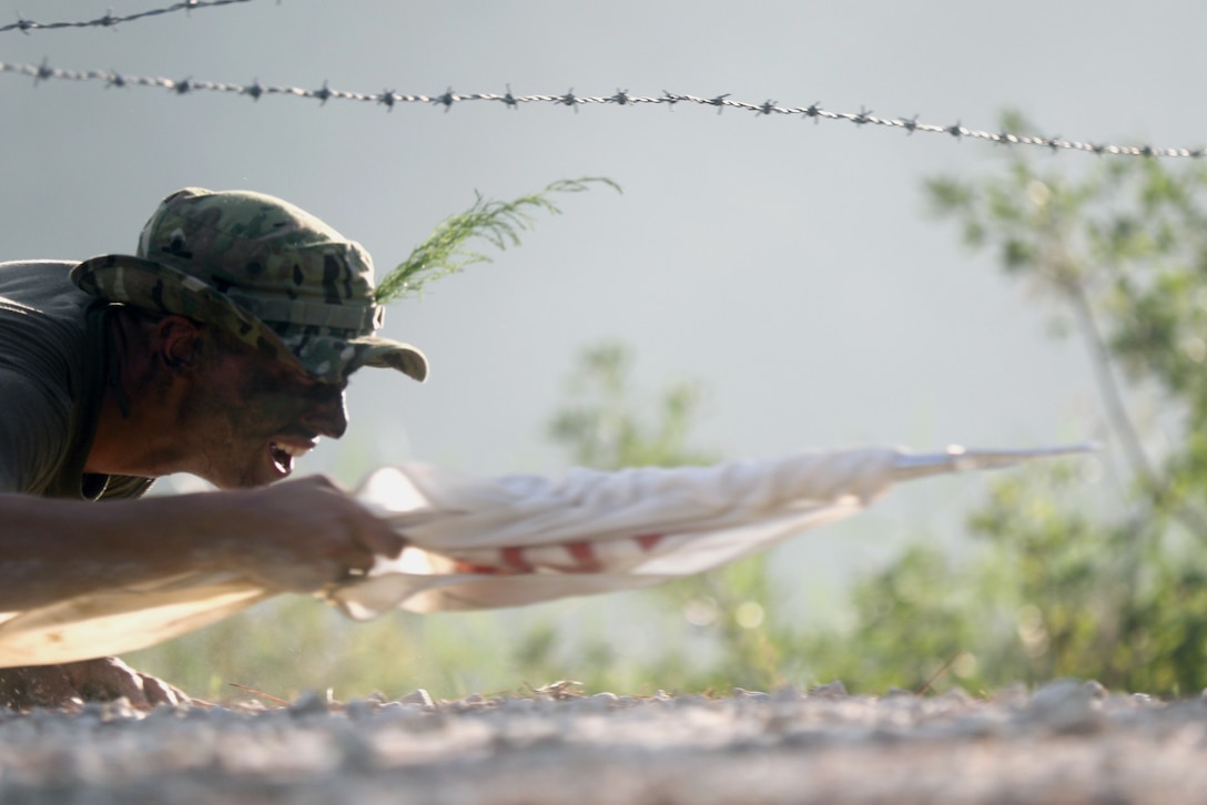 Paratrooper assigned to 37th Brigade Engineer Battalion, 82nd Airborne Division, navigates wire obstacle during Blood on the Water competition at Fort Bragg, North Carolina, September 7, 2018 (U.S. Army/Ryan Mercado)
