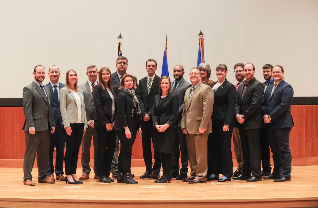 Graduates pose for a group photograph during the National Air and Space Intelligence Center Civilian Career Development Program graduation ceremony, at Wright-Patterson AFB, Ohio, Jan. 30, 2020. Since its beginning in 1978, NASIC'S Civilian Career Development Program, or CCDP, has trained and graduated more than 700 NASIC civilians. (U.S. Air Force photo Staff Sgt. Seth Ray Stang)