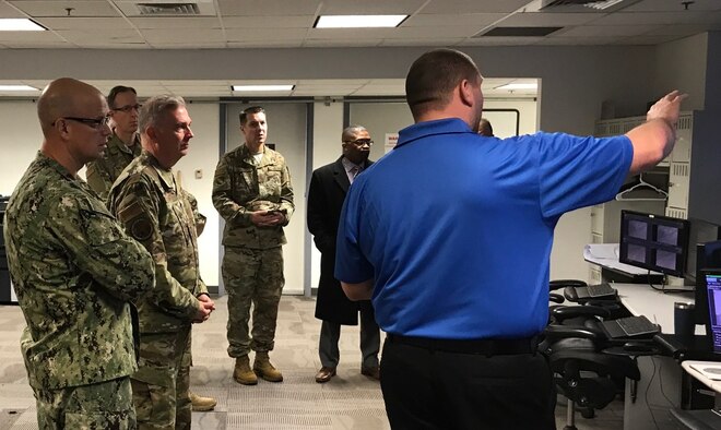 Naval District of Washington Commandant Rear Adm. Carl Lahti; Air Force District of Washington Commander Maj. Gen. Ricky N. Rupp; Air Force Element Commander and Joint Base Anacostia-Bolling, D.C., Vice Commander Col. Michael J. Zuhlsdorf; and AFDW Logistics Director Col. Christoff Gaub toured the Shore Operations Center, ShOC, at Naval District of Washington Headquarters, D.C., Feb. 6. This expansive facility oversees the Virtual Perimeter Monitoring Systems of Naval installations in the National Capital Region, to include JBAB and the Naval Academy in Annapolis, Maryland. The system uses multiple layers of security at the defined perimeter to detect unauthorized access or breaching at the installations. (U.S. Air Force photo/Lt. Col. Michael Garrott)