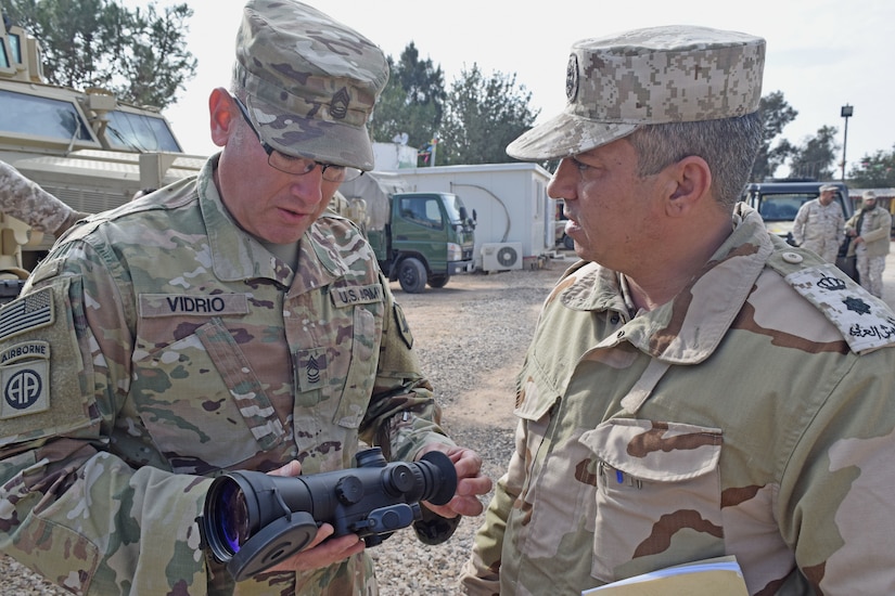 A U.S. Army Soldier (left), with Military Engagement Team-Jordan, 158th Maneuver Enhancement Brigade, Arizona Army National Guard, discusses functionally of a night vision device with a Jordan Armed Forces-Arab Army (JAF) Soldier during a Mine Resistant Ambush Protected Wheeled Armor Vehicle Subject Matter Expert Exchange at a base outside of Amman, Jordan in January. The U.S. military has a long-standing relationship with Jordan to support our mutual objectives by providing military assistance to the JAF consistent with our national interests. (U.S. Army photo by Sgt. 1st Class Elvis Sierra)