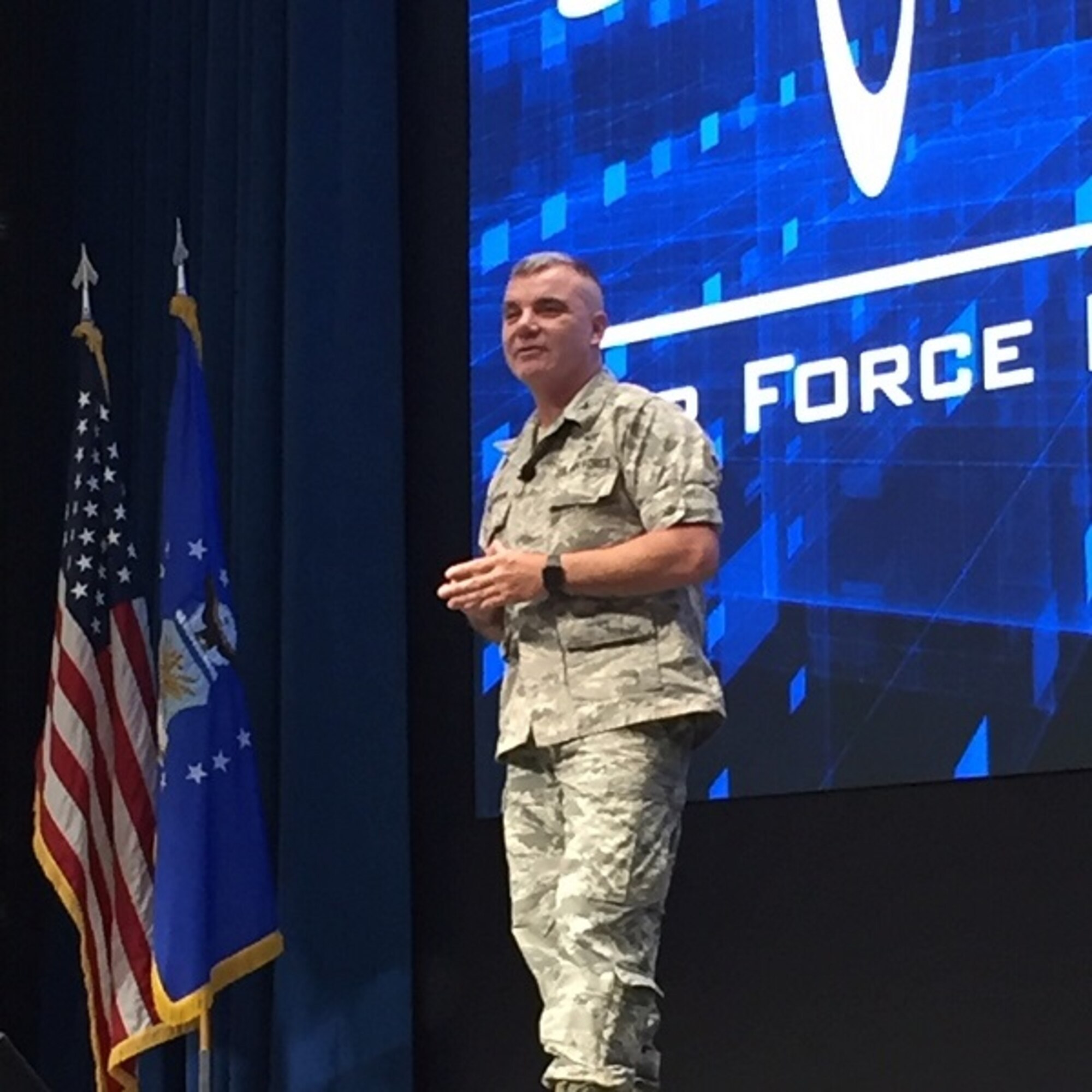 Retired Col. Robert Swanson Jr. speaks in front of hundreds of graduate students and faculty Jan. 16 at the Air Force Institute of Technology at Wright-Patterson Air Force Base. Swanson is a suicide attempt survivor and shared his insights on recovery and getting mental health help. (U.S. Air Force photo/Katie Scott)