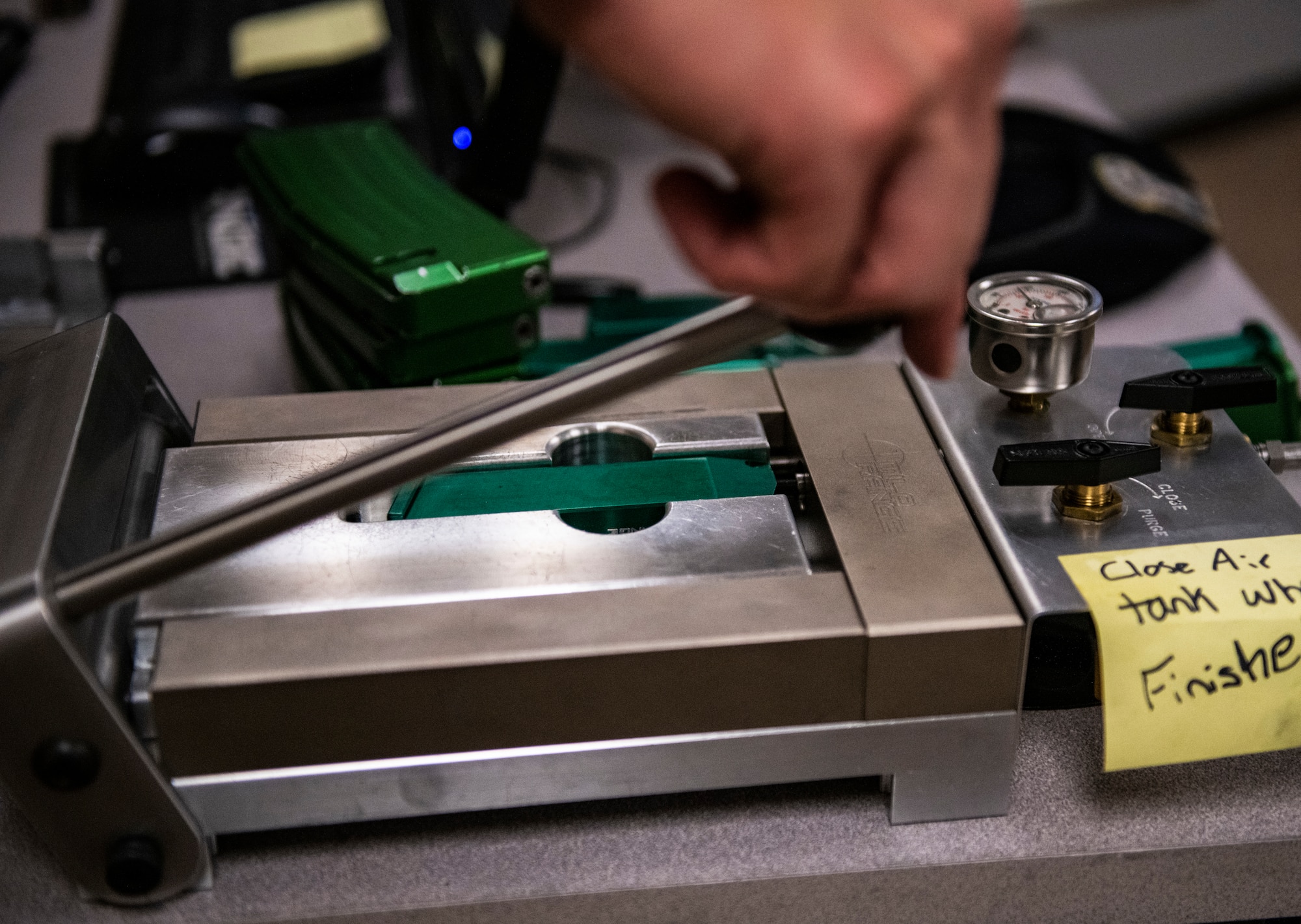 U.S. Air Force Staff Sgt. Michael McDowell, 325th Security Forces Squadron standards and evaluations evaluator, fills a M9 training magazine with compressed air at Tyndall Air Force Base, Florida, Feb. 5, 2020. The magazines simulate recoil to enhance the feel and operation of firearms during training. (U.S. Air Force photo by Senior Airman Stefan Alvarez)