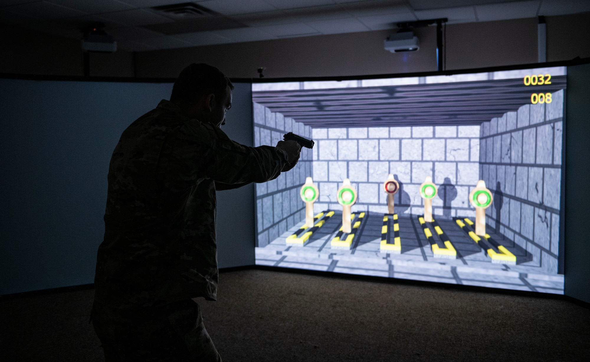 U.S. Air Force Staff Sgt. Thomas Badders, 325th Security Forces Squadron noncommissioned officer in charge of confinement, shoots at virtual targets at Tyndall Air Force Base, Florida, Feb. 5, 2020. Security Forces uses the Multiple Interactive Learning/Training Objectives Range to hone thier skills without the need to fire live rounds. (U.S. Air Force photo by Senior Airman Stefan Alvarez)