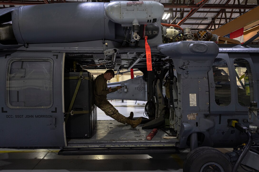 A photo of an Airman inspecting a tool.
