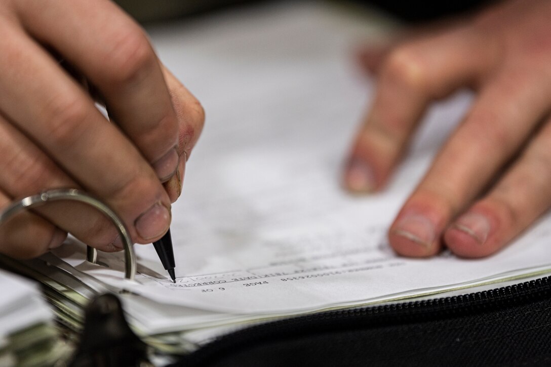 A photo of an Airman performing an aircraft inspection.
