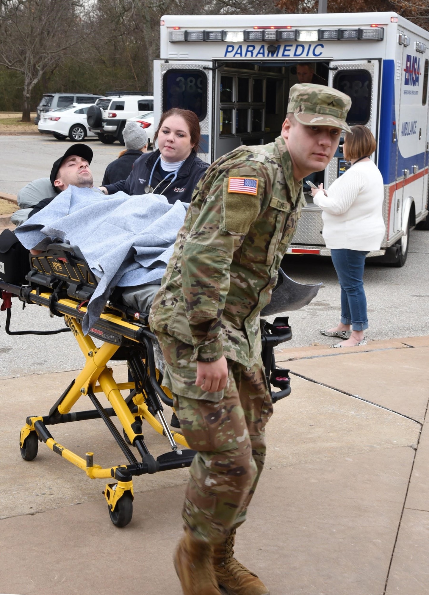 An EMSA EMT and a member of the Oklahoma Army National Guard bring Airman First Class James Lambert, 552nd Training Squadron, into a hospital at Metro Tech Health Careers Center during a mass casualty exercise Jan. 30. The joint effort event between Metro Tech, Tinker Air Force Base, the Army National Guard, Oklahoma City Fire and Police departments and EMSA saw between 300-400 participants which helped the students receive a more real-world experience to practice their knowledge and skills. (U.S. Air Force photo/Kelly White)