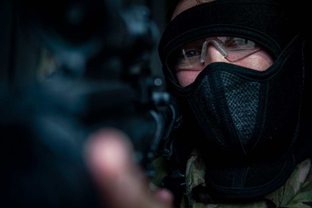 Photo of an Airman aiming down his sight.