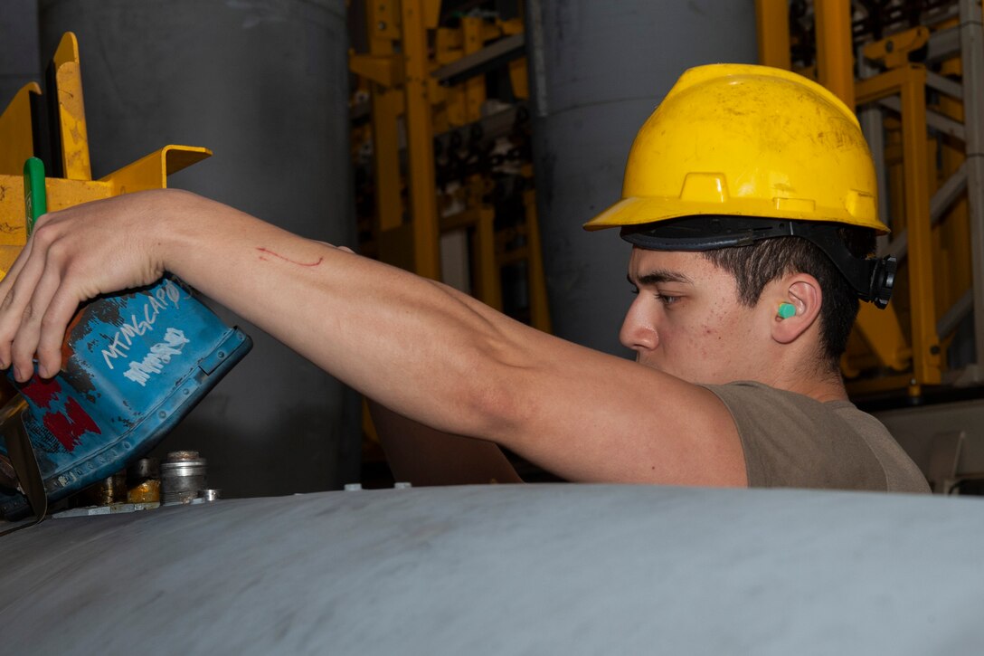Photo of an Airman inspecting a fuel cell