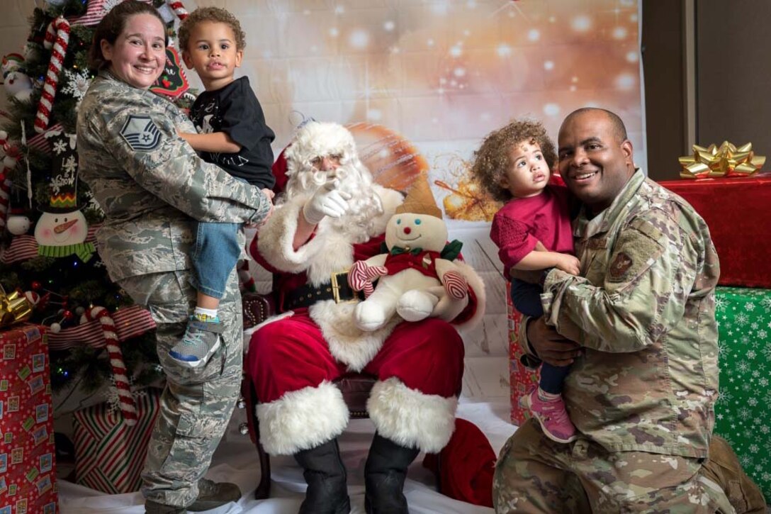 A family poses with Santa Claus.