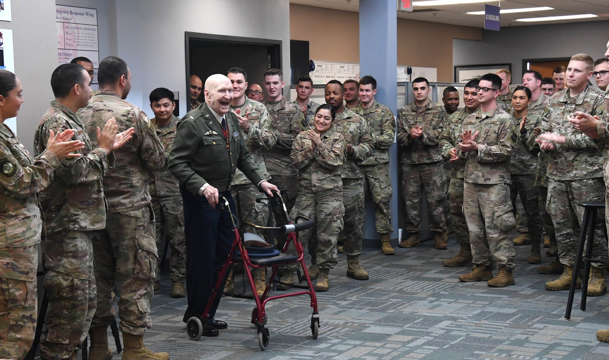 U.S. Air Force retired Col. Gail S. Halvorsen, the Berlin Candy Bomber, is greeted by an outburst of clapping hands from the crowd during his visit to Travis Air Force Base, California, Jan. 31, 2020. As part of his visit, Halvorsen visited the 821st Contingency Response Squadron where he spoke about the importance of being a part of the airlift team and told Airmen there was no greater service than to save the lives of others. (U.S. Air Force photo/ TSgt Liliana Moreno)