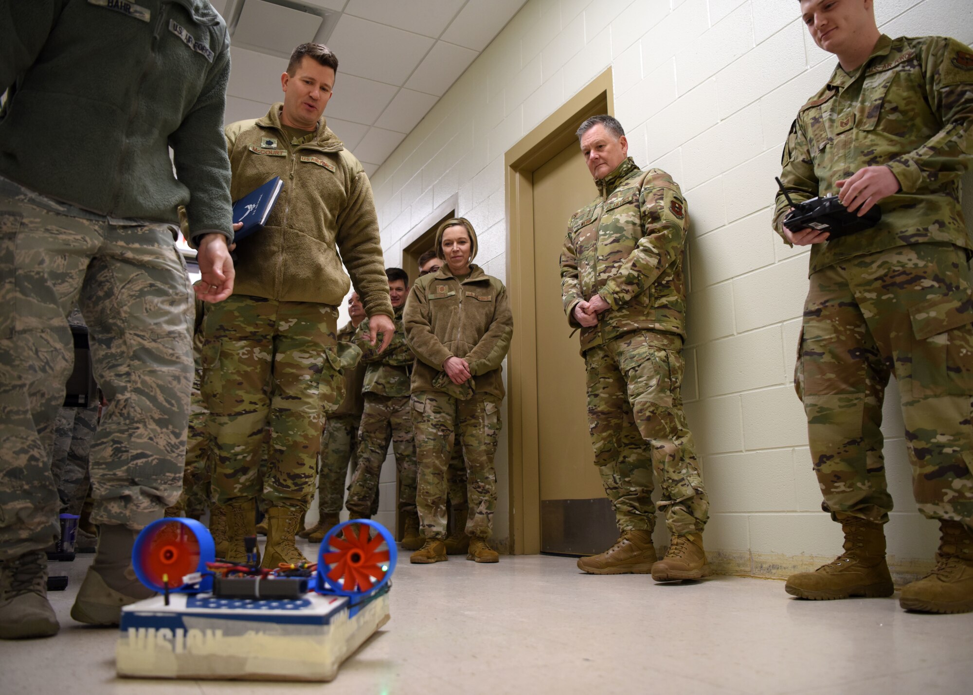 U.S. Air Force Lt. Gen. Brad Webb, and Chief Master Sgt. Juliet Gudgel, command team for Air Education and Training Command, watch a handmade hovercraft float across the ground at the 312th Training Squadron on Goodfellow Air Force Base, Texas, Feb. 7, 2020. The hovercraft is one of many projects that Special Instruments Training students build during their free time. (U.S. Air Force photo by Airman 1st Class Ethan Sherwood)