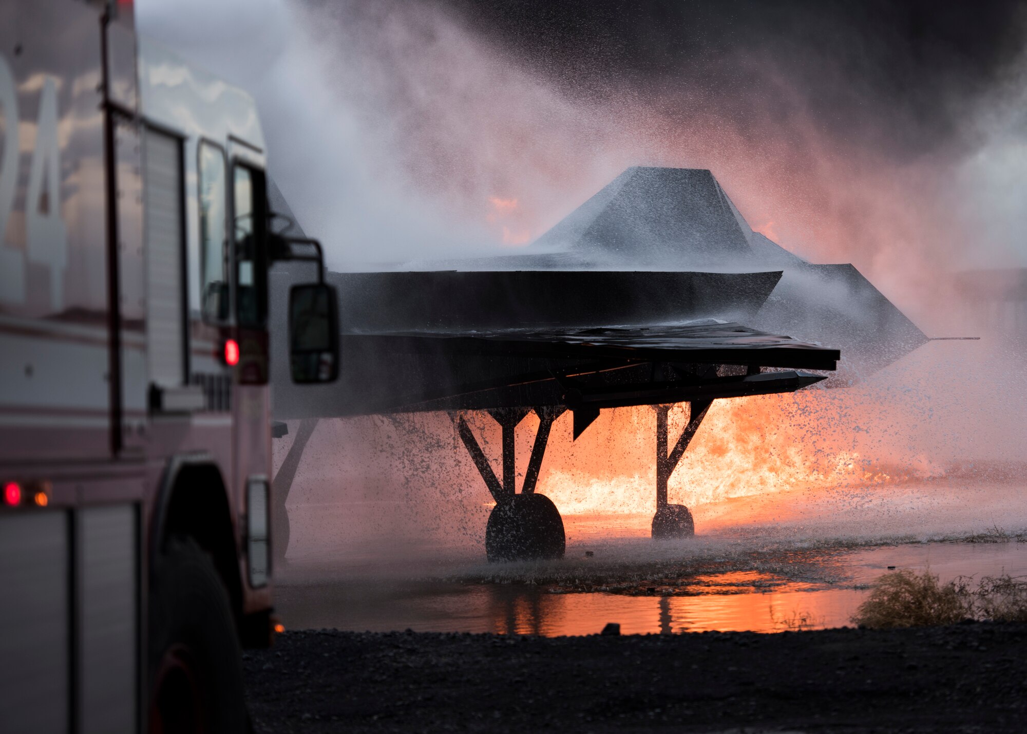Fire truck hoses down a fire during a live-fire training exercise