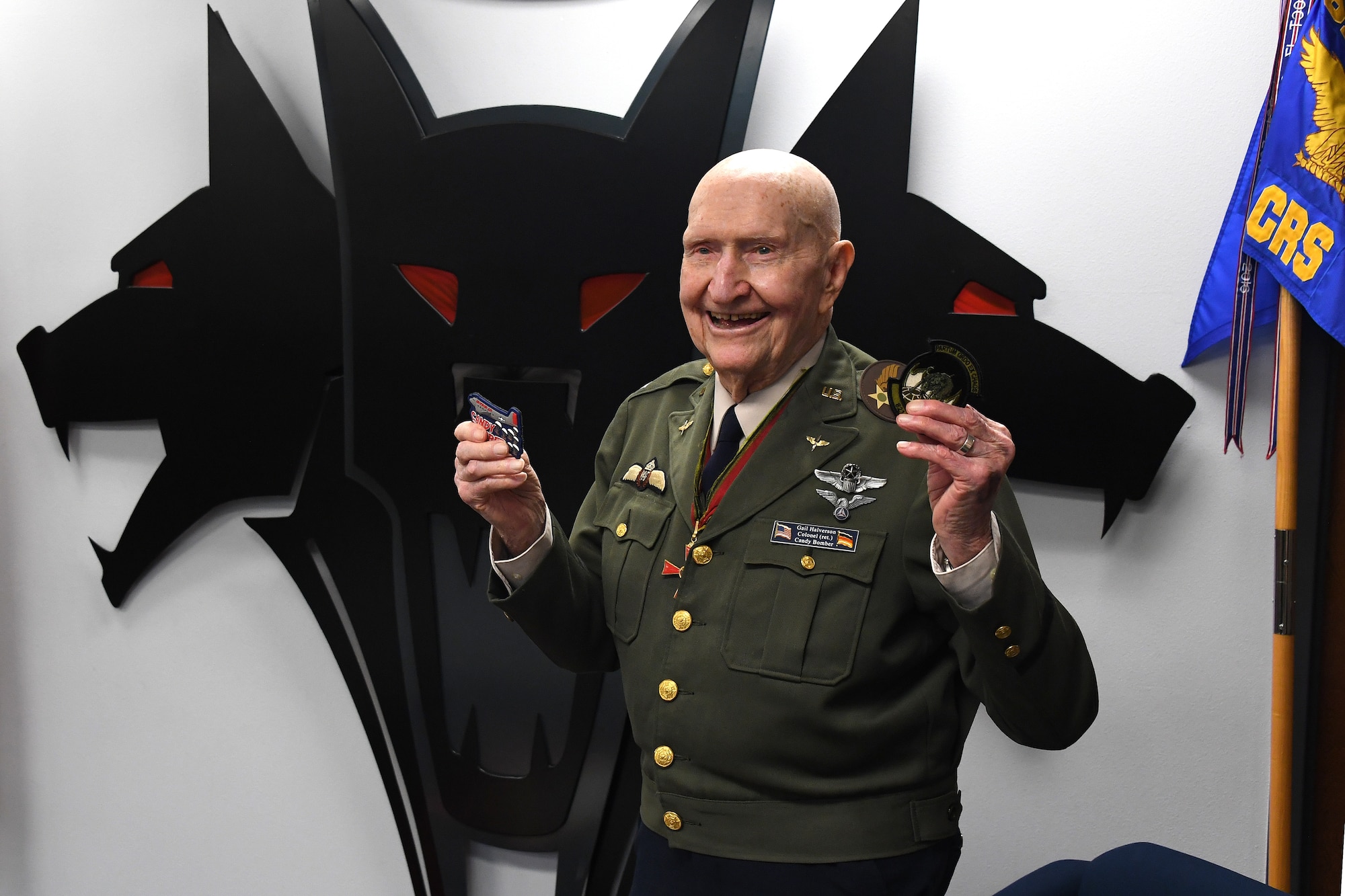 U.S. Air Force retired Col. Gail S. Halvorsen, the Berlin Candy Bomber, smiles as he displays the patches given to him by  Airmen assigned to the 821st Contingency Response Squadron during his visit to Travis Air Force Base, California, Jan. 31, 2020. The 99-year old war hero shared his amazing story with the Airmen and as a tribute to his legacy, he was inducted into the squadron's "Super Howl" hall of fame. The Super-Howl was initiated by the squadron as a way to recognize military veterans who visit their unit and have played an important role in the nation’s history. The squadron displays this honor on a plaque at the unit where they add the name of the inductee next to the operation he or she served in. (U.S. Air Force photo/ TSgt Liliana Moreno)