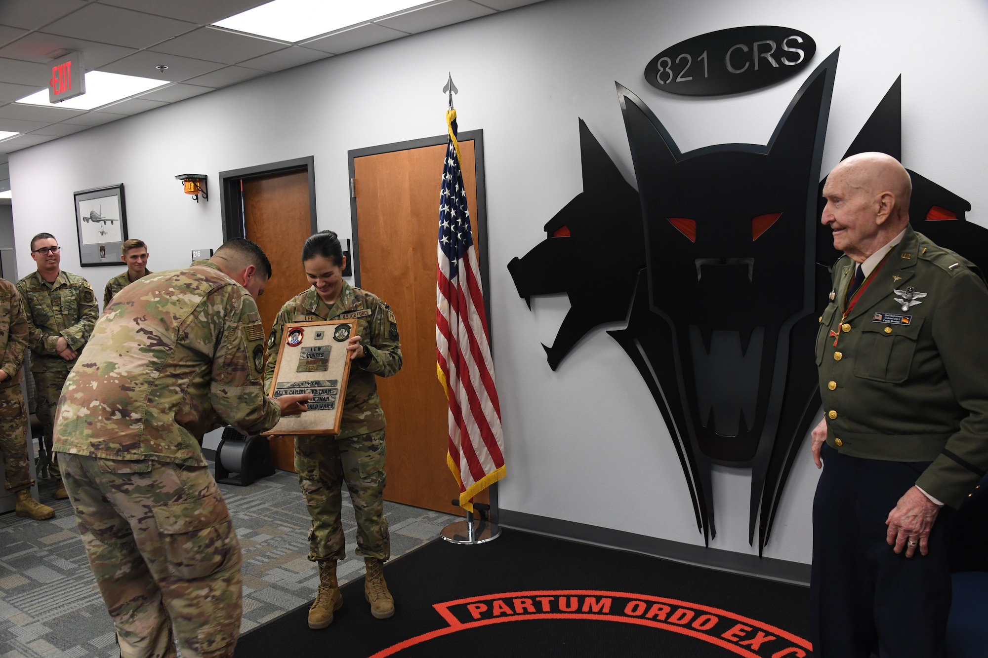 U.S. Air Force retired Col. Gail S. Halvorsen,  right, the Berlin Candy Bomber, observes as Master Sgt. Christopher Swartz, left, 821st Contingency Response Squadron aerial port flight chief, displays his name on a plaque in recognition of his legacy as the Berlin Candy Bomber, Jan. 31, 2020, Travis Air Force Base, California. The 99-year old war hero shared his amazing story with the Airmen and as a tribute to his legacy, he was inducted into the squadron's "Super Howl" hall of fame. The Super-Howl was initiated by the squadron as a way to recognize military veterans who visit their unit and have played an important role in the nation’s history. The squadron displays this honor on a plaque at the unit where they add the name of the inductee next to the operation he or she served in. (U.S. Air Force photo/ TSgt Liliana Moreno)