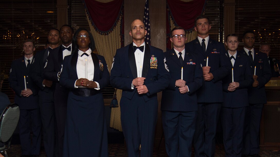 U.S. Air Force Airmen stand in a formation during a candle lighting ceremony at the Chief’s Induction Ceremony, Jan. 31, in Tampa, Fla. The formation included nine Airmen to signify each of the nine ranks of the enlisted Air Force structure.