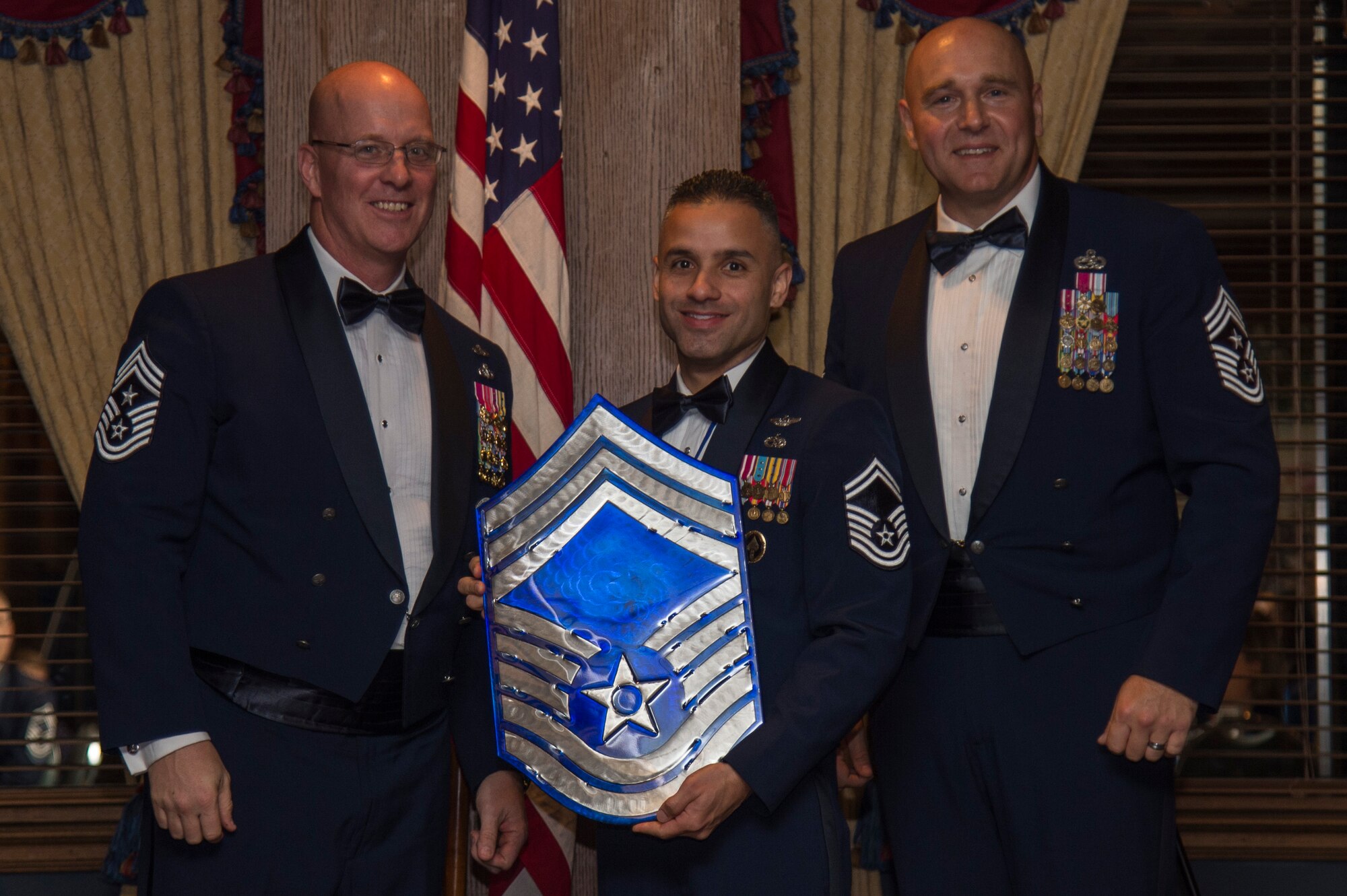 U.S. Air Force Chief Master Sgt. Daniel Simpson, the 18th Air Force command chief (left), chief master sergeant select, Senior Master Sgt. Jorge Bonilla, the Joint Special Operations University enterprise management course director (center) and Chief Master Sgt. Anthony Green, the 6th Air Refueling Wing command chief (right), pose for a photo, during a Chief’s Induction Ceremony, Jan. 31, in Tampa, Fla.  Bonilla was one of nine Team MacDill Airmen selected for promotion to chief master sergeant for 2019.