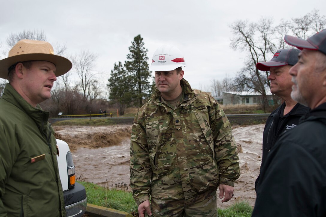 Justin Stegall, Mill Creek Project Manager for the Walla Walla Corps of Engineers, briefs Lt. Col. Christian Dietz, Commander of the Walla Walla District Corps of Engineers, and Walla Walla County Commissioners Todd Kimball and Greg Tompkins on the status of the Mill Creek Channel.