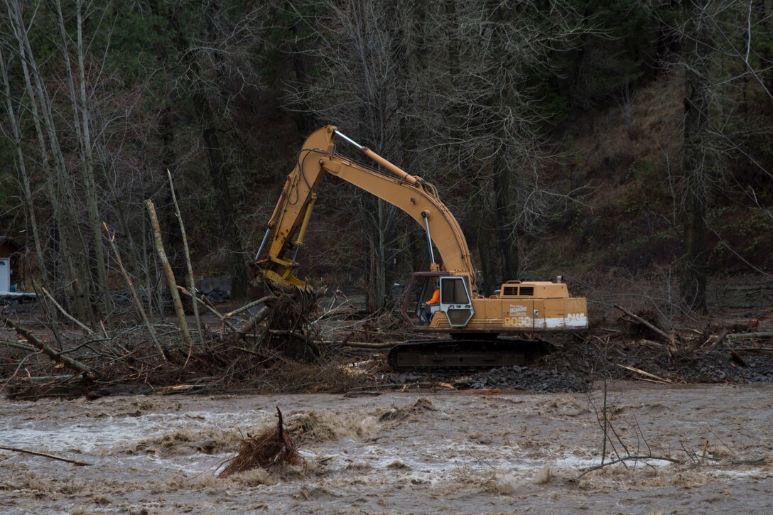 Excavator removes debris from Mill Creek Channel.