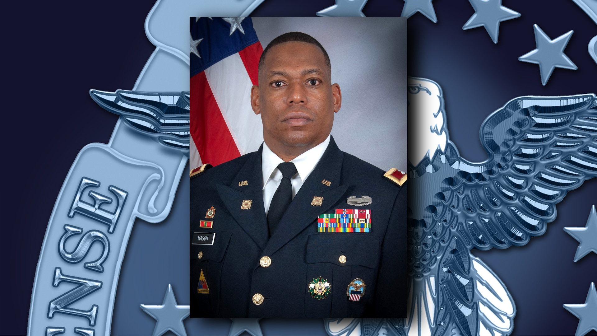 Soldier in dress green uniform poses in front of a U.S. flag.