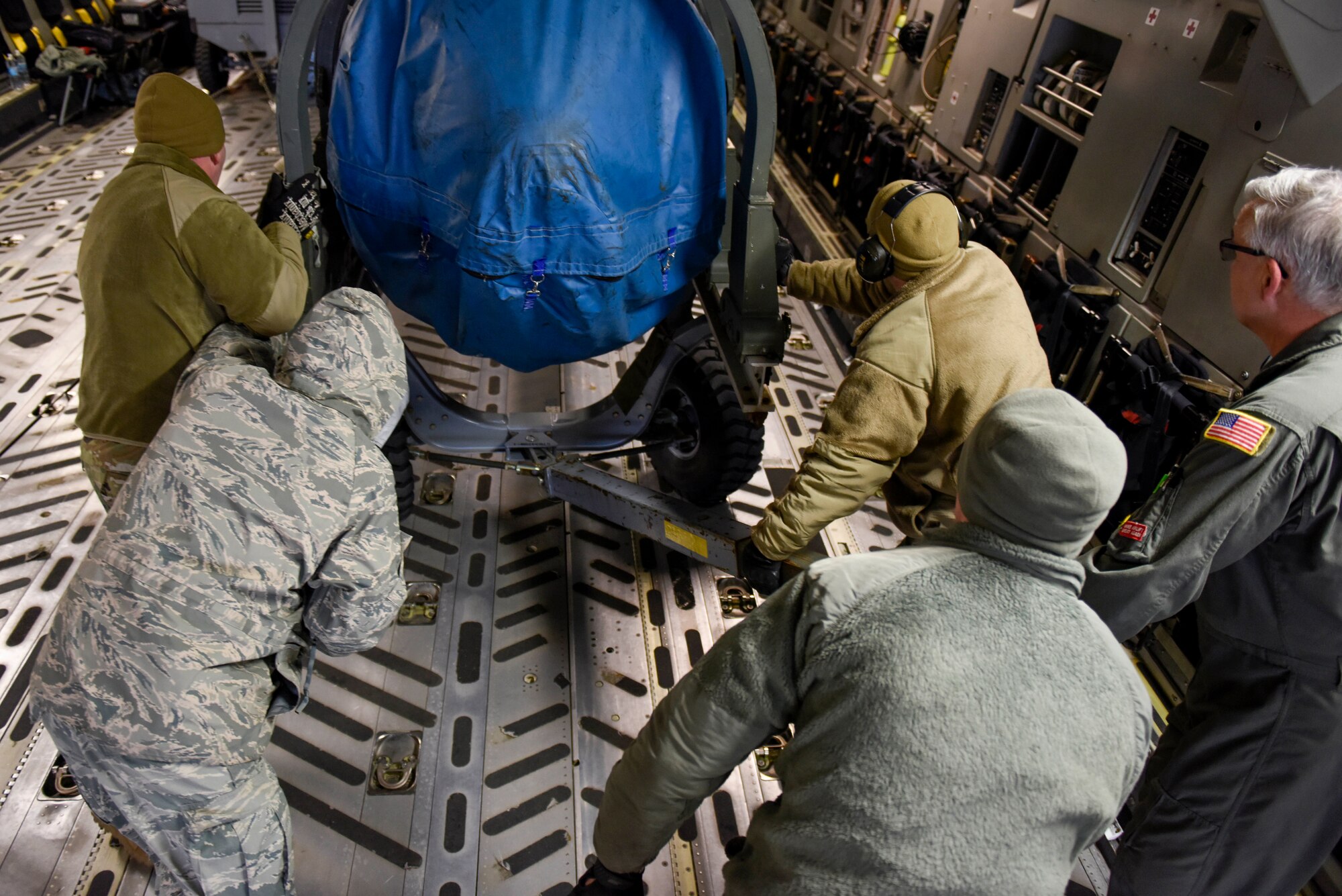 Airmen assigned to the Ohio National Guard’s 180th Fighter Wing and the 167th Airlift Wing load cargo onto a C-17 assigned to the 167th AW at the 180FW, Feb. 4, 2020. The C-17 was loaded with equipment to support the 180FW's involvement in exercise Green Flag-West. Green flag is a realistic, Air-to-Surface, joint training exercise designed to improve interoperability between aircraft while supporting ground troops by allowing U.S. military branches, as well as other NATO and allied nations, an opportunity to work together, as they would in military operations around the world.