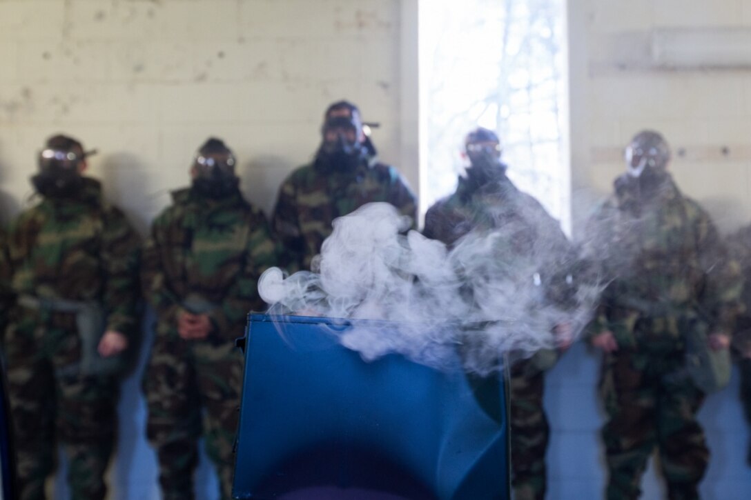 U.S. Marines with 3rd Battalion, 2nd Marine Regiment, 2nd Marine Division watch the gas rise from broken chlorobenzylidene malonitrite tablets, more commonly known as CS tablets, during gas chamber training at Camp Lejeune, North Carolina, Jan. 29, 2020. The Marines participated in the training course to enhance their confidence and proficiency with their chemical, biological, radiological, and nuclear (CBRN) equipment. (U.S. Marine Corps photo by Sgt. Abrey Liggins)