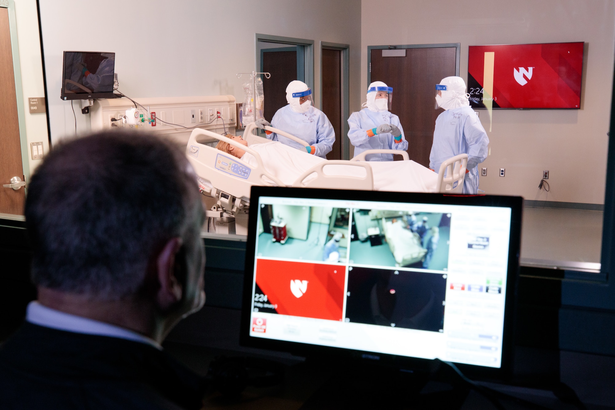 Bob Valentine (far left), The Center for the Sustainment of Trauma Readiness Skills Omaha administrator, manages and observes a simulated scenario as Maj. Kisha Wood, C-STARS deputy director, Lt. Col. Elizabeth Schnaubelt, C-STARS Omaha director, and Tech. Sgt. Victor Kipping, public health non-commissioned officer in charge, assess a simulated patient and communicate their course of action at the University of Nebraska Medical Center, Omaha, Nebraska, Jan. 3, 2020. The U.S. Air Force’s C-STARS Omaha program, which was established in 2018, partners with The University of Nebraska Medical Center, focusing on advancing the training of medical Airmen in infectious diseases that they might see during deployment. (Courtesy photo)