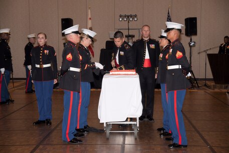 Commanding officer of CLB-5 cuts birthday cake during Marine Corps' birthday ball ceremony.