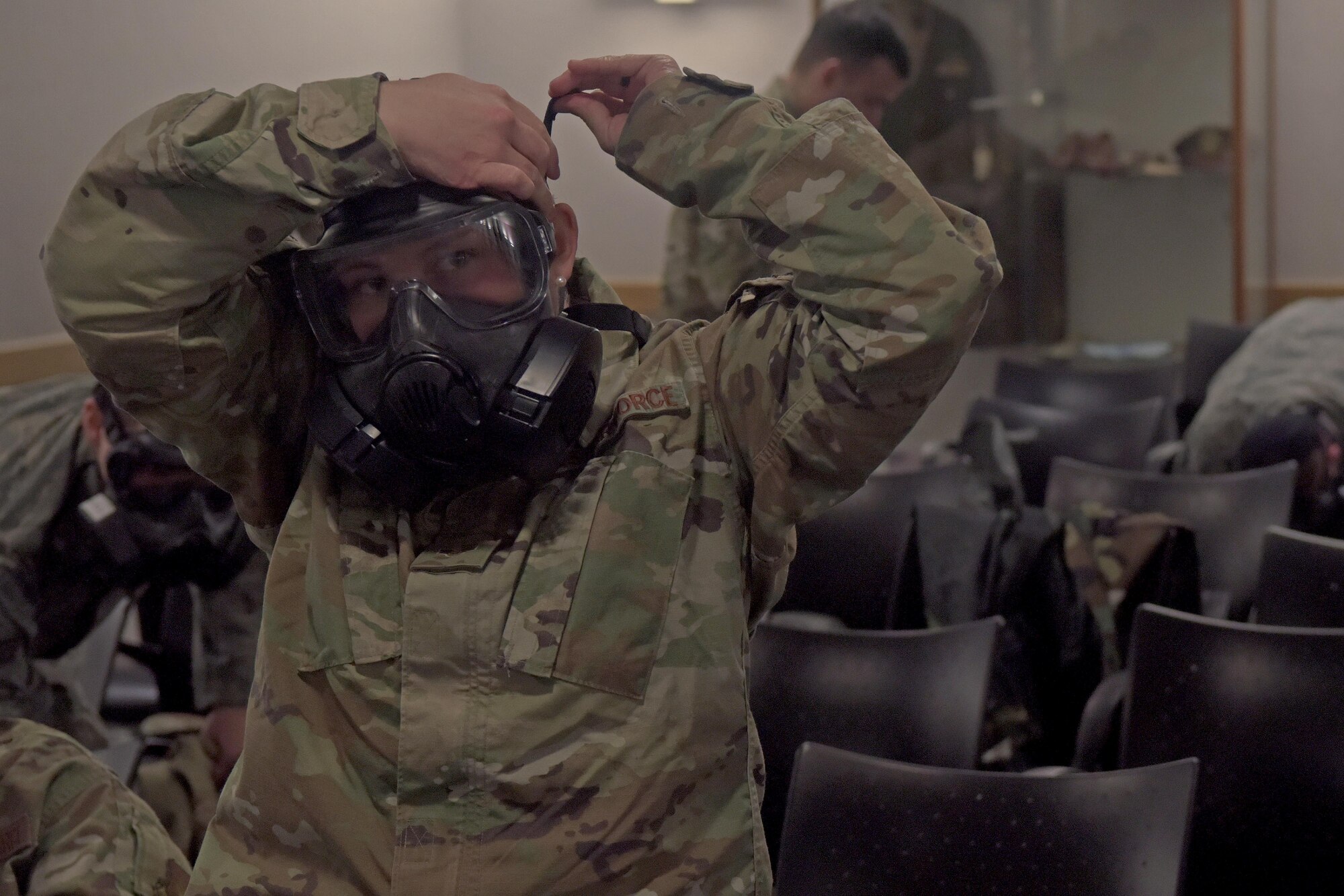 Senior Airman Alyssa Priest, 100th Logistics Readiness Squadron decentralized material support journeyman, puts on her gas mask during a training session for an exercise which will include agile combat concepts at RAF Mildenhall, England, Feb. 7, 2020. Agile Combat Employment  aims to increase Airmen readiness and ensure Airmen and aircraft are ready for potential contingencies across the spectrum of military operations. (U.S. Air Force photo by Senior Airman Benjamin Cooper)